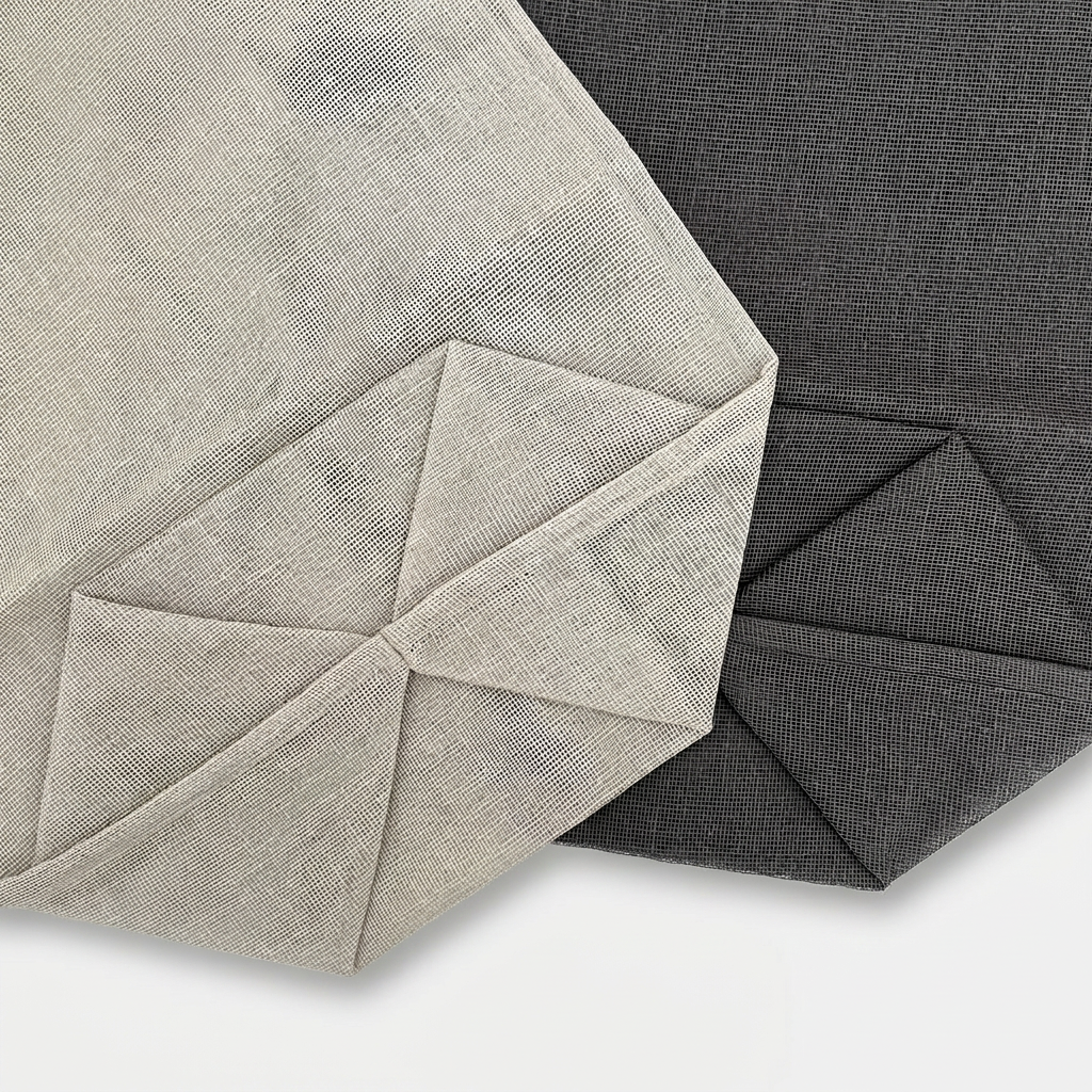 Kitchen storage bags, 100% cotton gauze in natural and charcoal, close-up view of pleated bases.