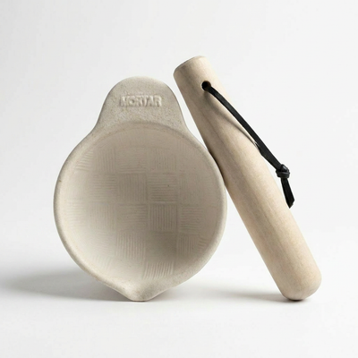 
                    
                      Hinoki cypress Surikogi pestle and mortar set, angled view. Light wood pestle, black cord, creamy white mortar with textured…
                    
                  