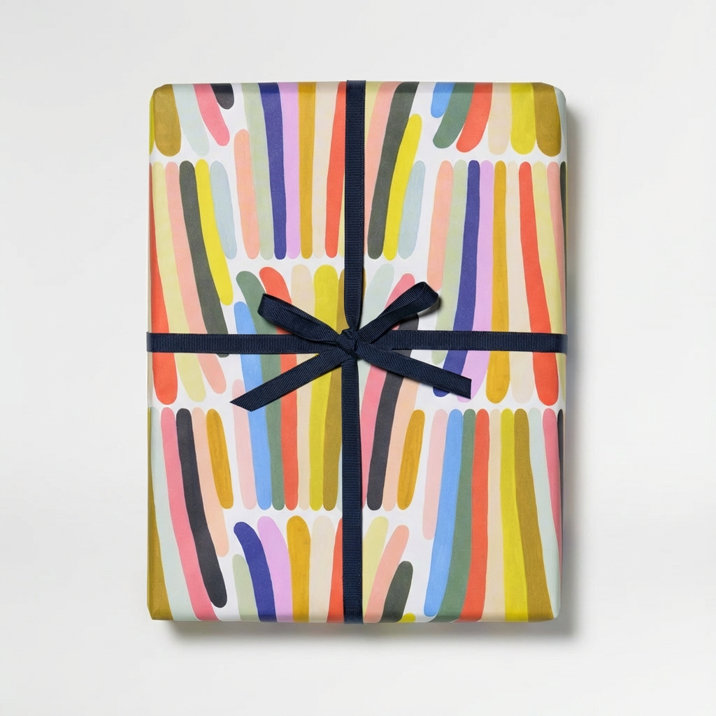 Rainbow Stripes recycled wrapping paper, abstract multicolored stripes, wrapped gift tied with dark blue ribbon, top-down…