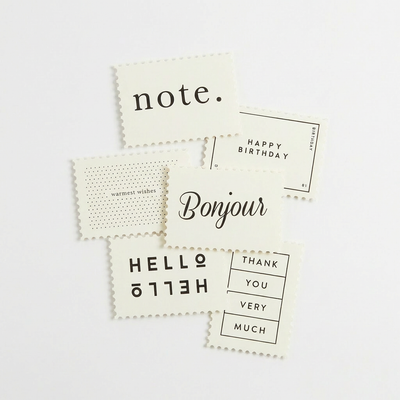
                    
                      Katie Leamon Assorted Notecards, set of 6 ivory cardstock with black text, stamp-edge design, scattered flat lay showing all…
                    
                  