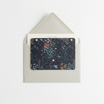
                    
                      Zodiac Notecards, dark blue celestial and floral pattern, partially inserted in a light grey envelope, showing 'FOR YOU'…
                    
                  