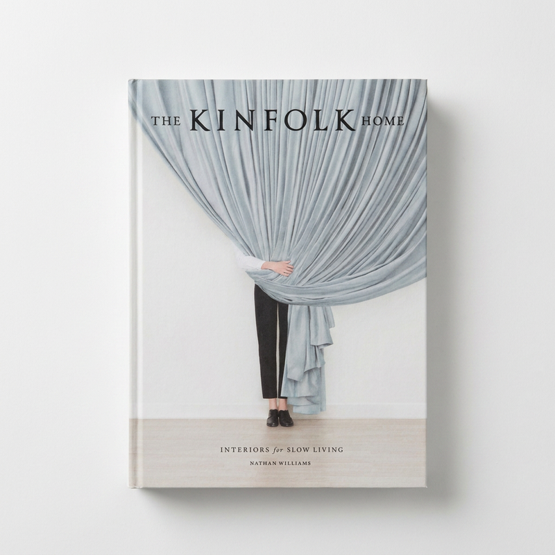 Hachette Book Group, The Kinfolk Home book, featuring a person peering from behind light blue/grey draped fabric, front view…