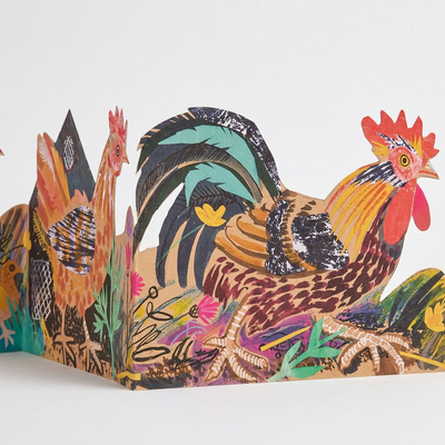 
                    
                      Three Fold Chickens die-cut card, Mark Hearld's vibrant illustration of roosters, hens, and floral accents, standing side…
                    
                  
