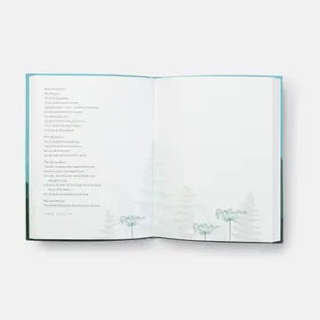 This Wild And Precious Life journal open view, showing left page with text and right page with faint misty tree illustration.