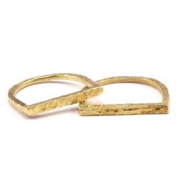 Hammered brass stacking ring on a white background