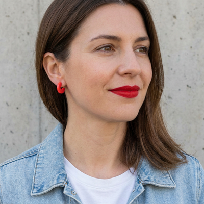 
                    
                      Mali Cherry Red acetate hoop earrings, on ear close-up view.
                    
                  
