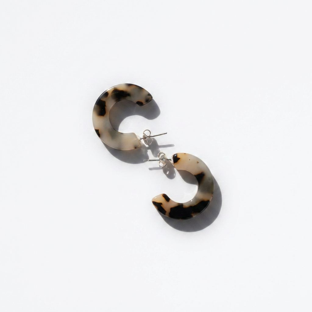 NAT + NOOR Ray hoop earrings, Ivory Tortoise acetate, flat lay pair on white, showing silver stainless steel posts.