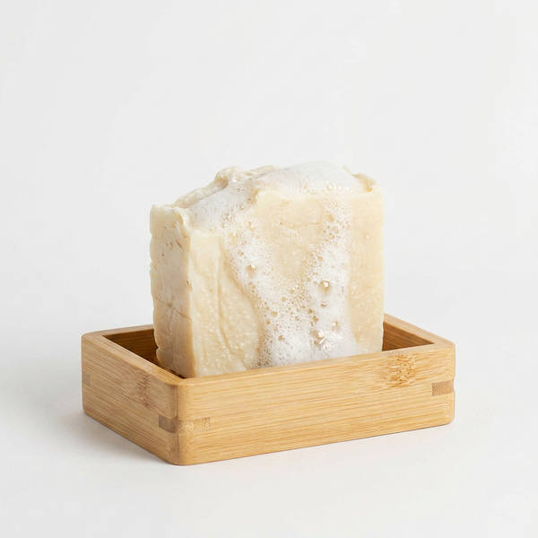 No Tox Life Moso Bamboo Soap Shelf, light brown bamboo, holding a lathered soap bar, front view on white.