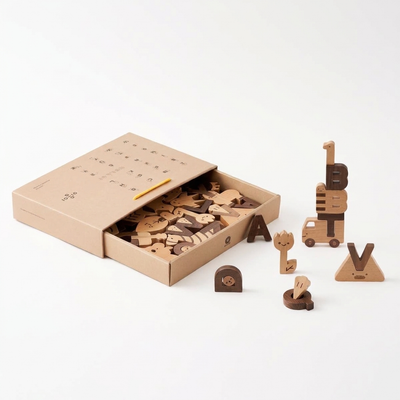 
                    
                      Alphabet Play Blocks, open box filled with beech and walnut wood letter blocks, with 'BT' stacked on a wood truck.
                    
                  