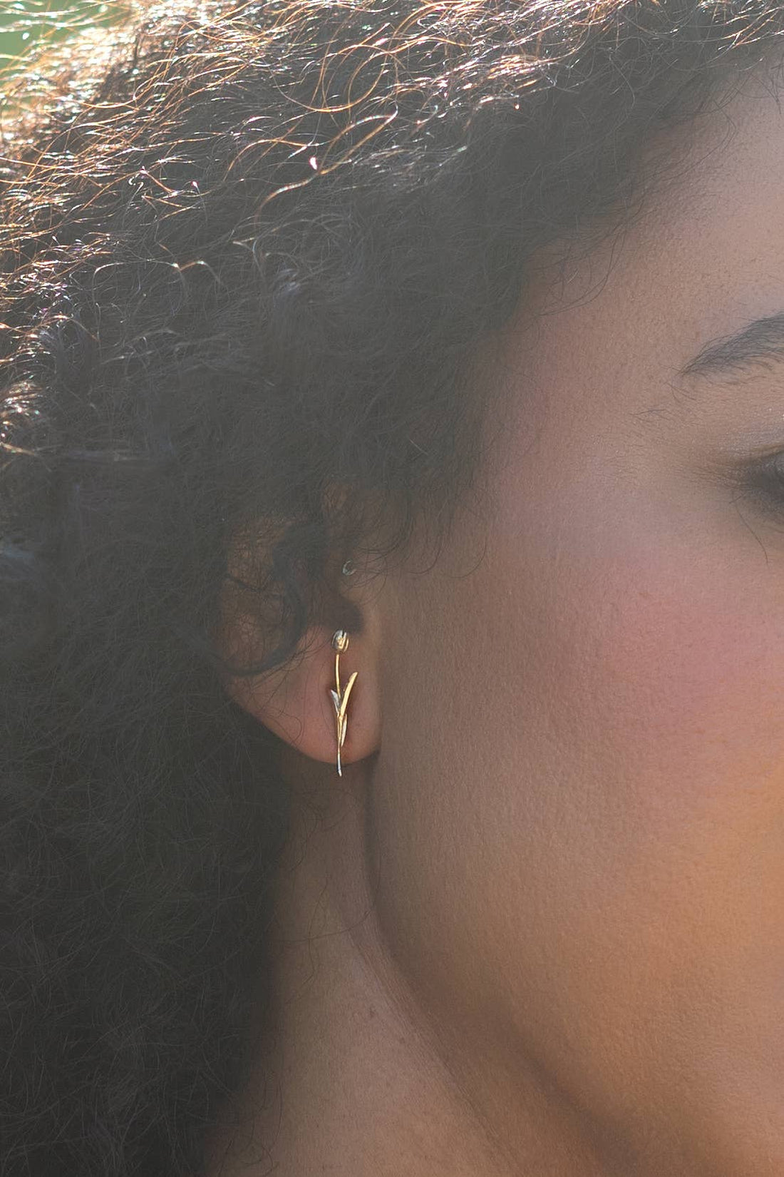 Holland Tulip Studs earrings, 18K gold-plated brass, close-up side view on ear.