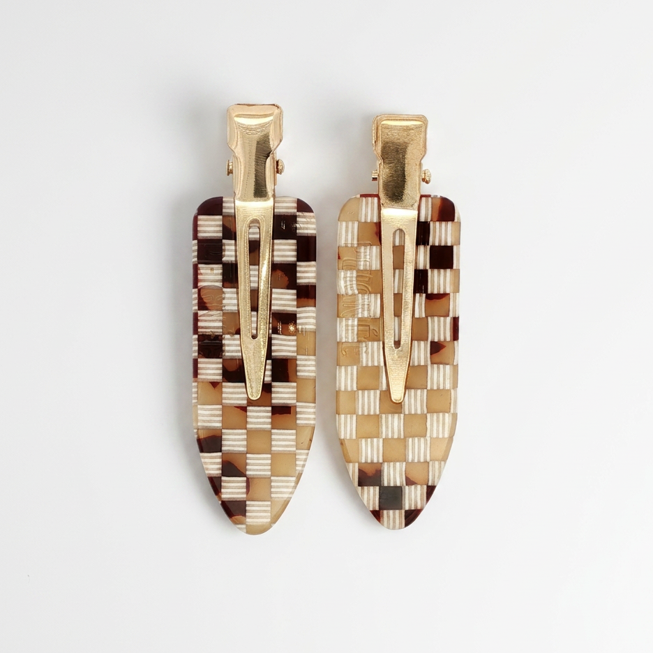 Peignee Paris Checkerboard Hair Clips, set of two, brown, tan, white cellulose acetate with gold clips, flat lay on white.