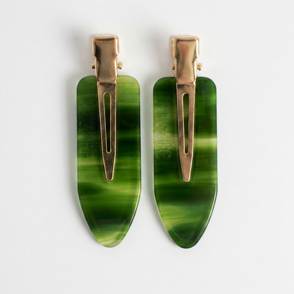 Peignee Paris Emerald Hair Clips, set of two, swirling emerald green acetate and gold-tone clips, flat lay on white.