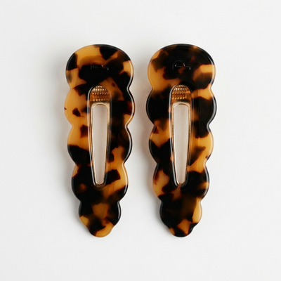 
                    
                      Peignee Paris Signature hair clips, tortoise acetate flat lay pair, front on white.
                    
                  