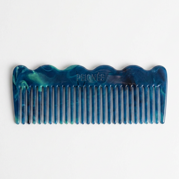 Peignee Paris Signature Wide-Tooth Wave Comb, rivoli blue and green marbled plant-based cellulose acetate, front on white.