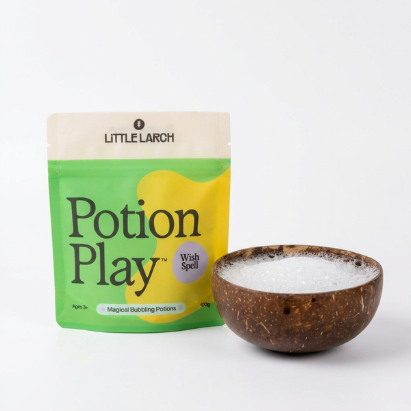 Little Larch Potion Play packaging with a coconut bowl containing a pretend magic potion, placed on a light gray background.