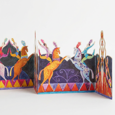 
                    
                      Art Angels Circus Die-Cut Card, Sarah Young illustration, vibrant circus horses and acrobats, unfolded angled view on white.
                    
                  