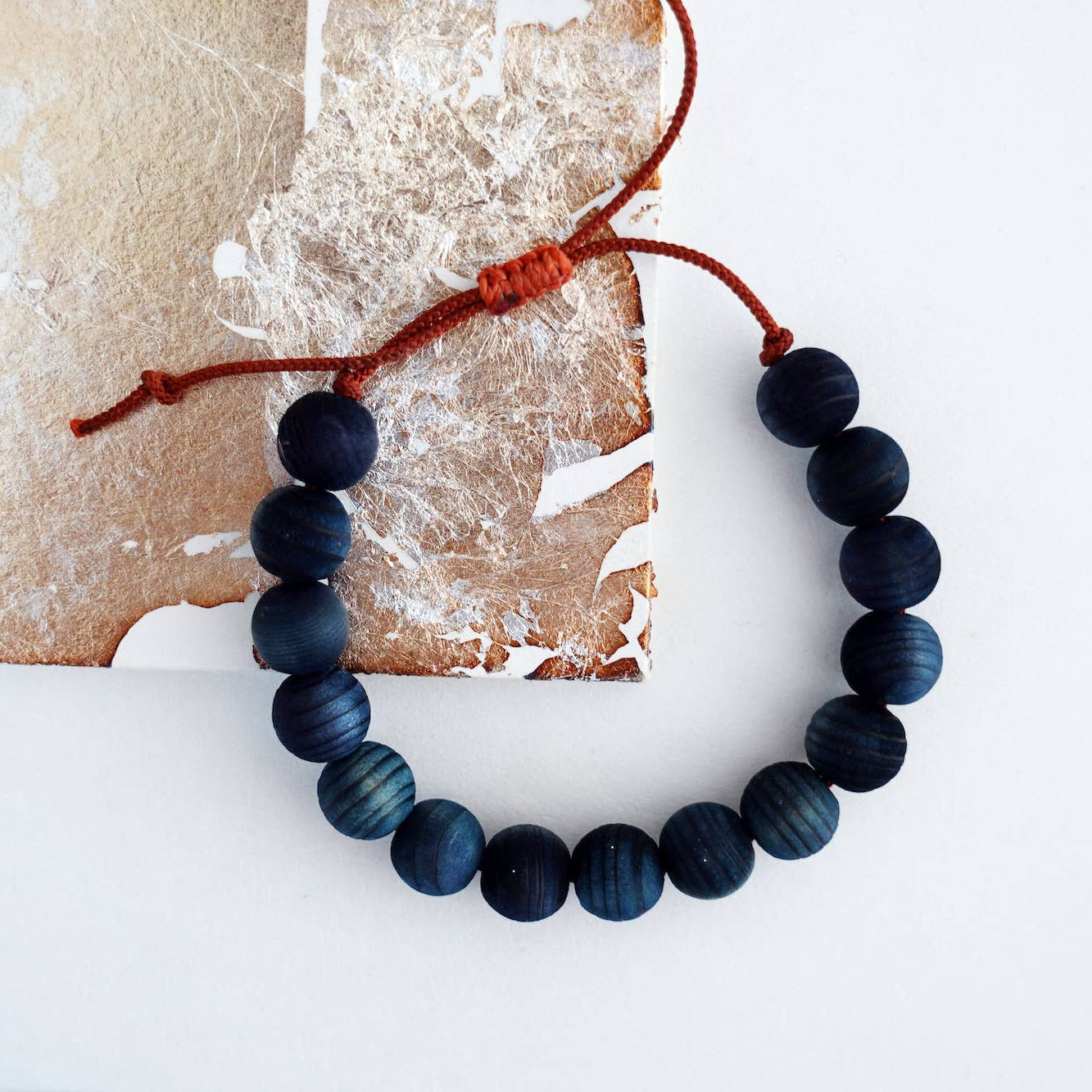 Indigo beaded bracelet on a textured surface