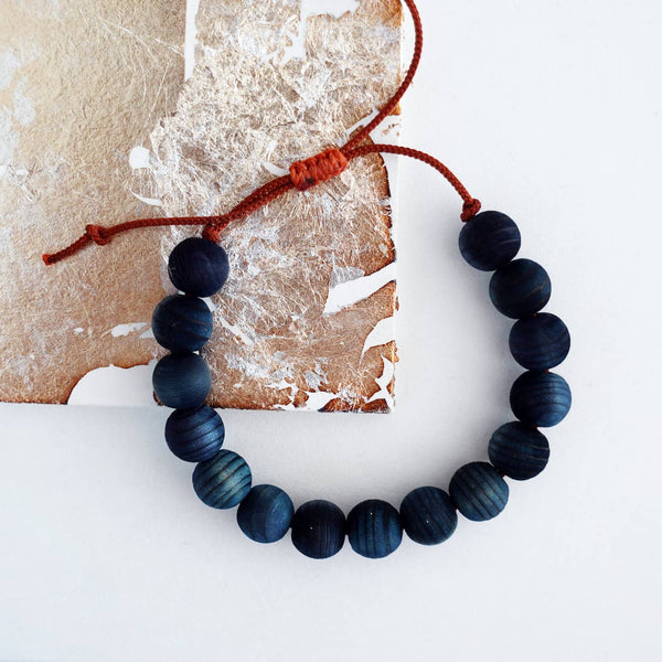 Indigo beaded bracelet on a textured surface