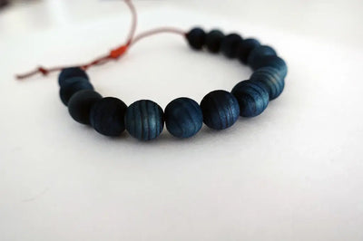 
                    
                      Indigo beaded bracelet on a white background
                    
                  