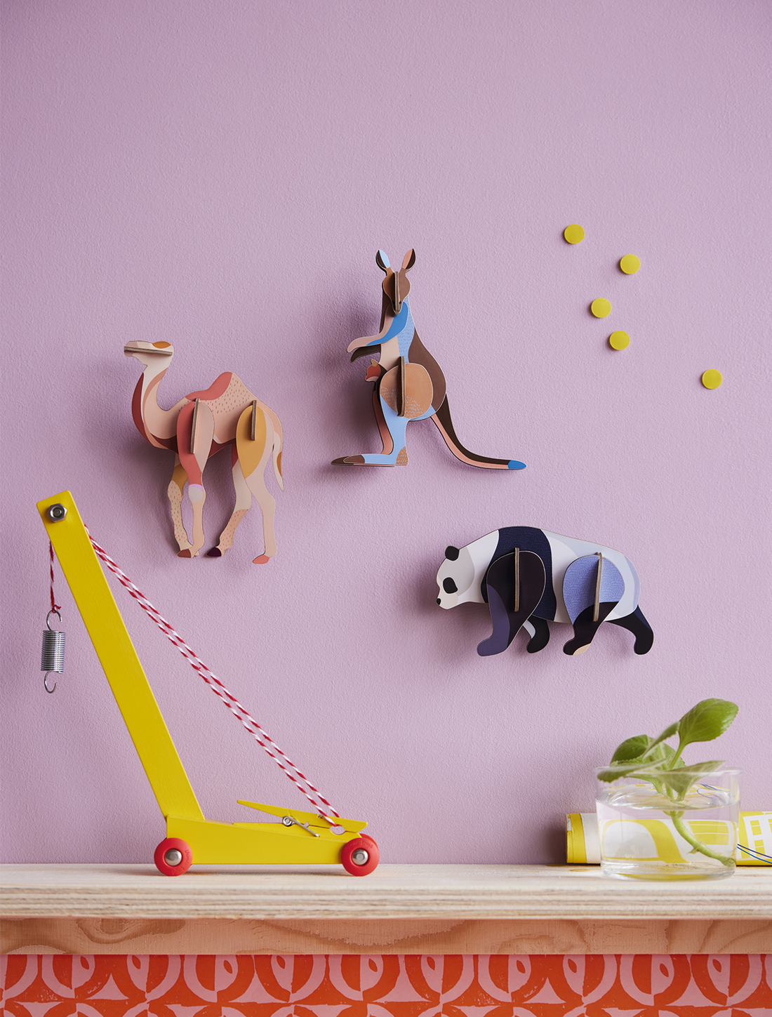 3d Kangaroo build kit, assembled recycled cardboard figure with vibrant multi-color graphic pattern, on wall.