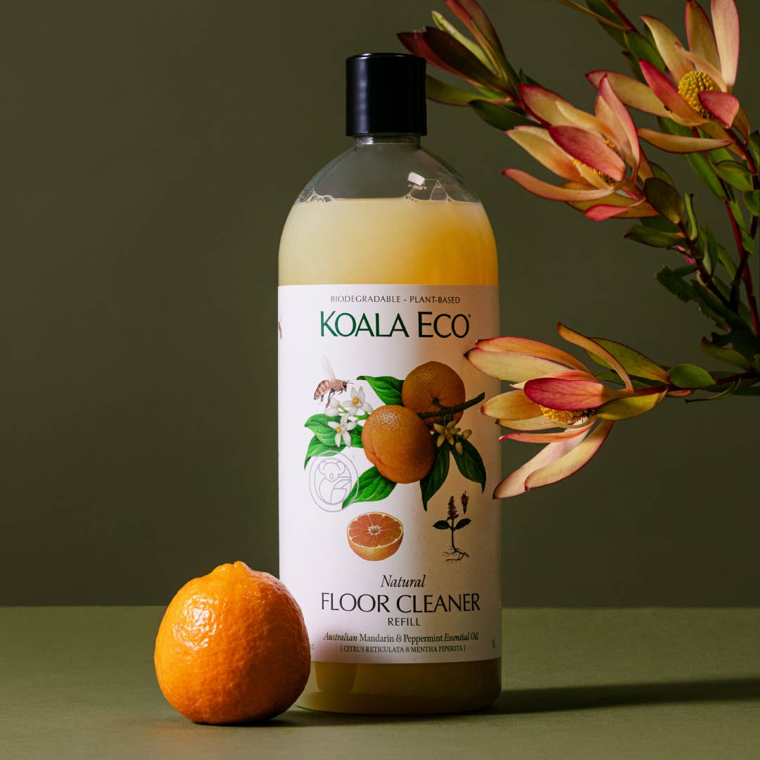 Mandarin & Peppermint Floor Cleaner Refill, clear bottle with light yellow liquid, displayed with a fresh mandarin fruit and…