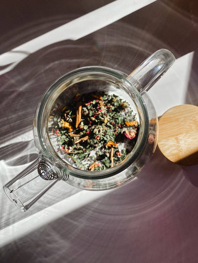 
                    
                      Borosilicate glass teapot, overhead view, with colorful loose leaf tea inside, visible stainless steel spiral infuser and…
                    
                  