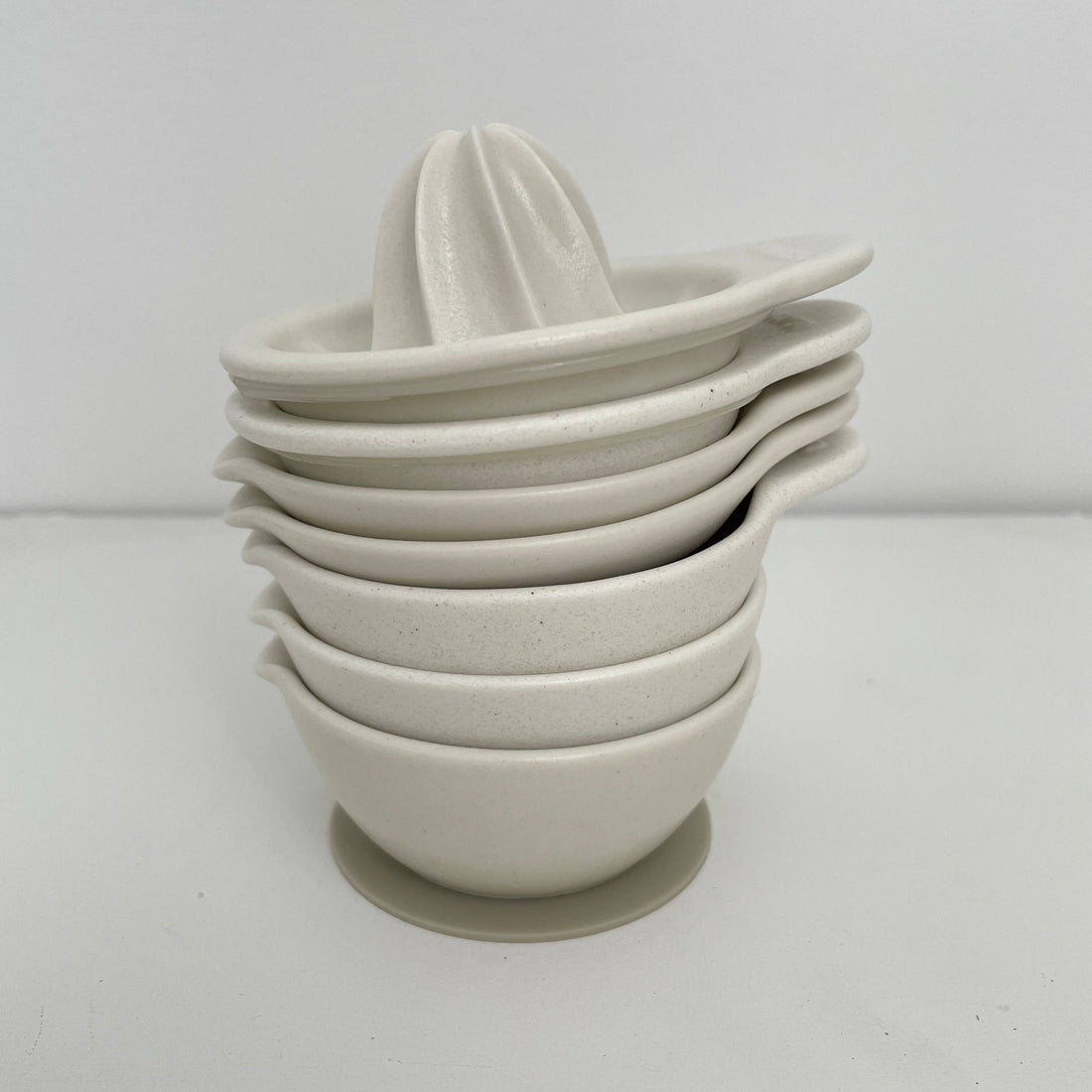 Fort & Field Japanese Ceramic Mortar bowls, white speckled porcelain, stacked with reamer on top, side view.