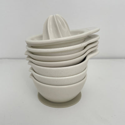 
                    
                      Fort & Field Japanese Ceramic Mortar bowls, white speckled porcelain, stacked with reamer on top, side view.
                    
                  