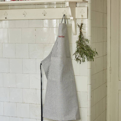 
                    
                      Sylvie Thiriez French Striped Cotton Apron, black and white vertical stripes, red 'Merbe' embroidery, hanging front view.
                    
                  