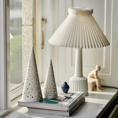 
                    
                      Nobili Cone bone china ceramic tealight candle holders in two sizes, with light softly glowing through numerous small…
                    
                  