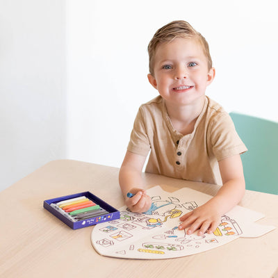 
                    
                      Jumbo Rocket Paper Coloring Book in-use, open on a light wood table. Child colors space-themed designs with a blue chalk…
                    
                  