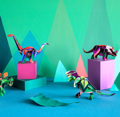 
                    
                      3D Triceratops dinosaur model kit, geometric multi-color pattern, with other dinosaur models arranged on blocks in a vibrant…
                    
                  