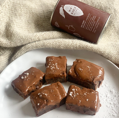 
                    
                      Dark Drinking Chocolate mix can behind five rich chocolate brownies with glossy ganache and flaky sea salt.
                    
                  