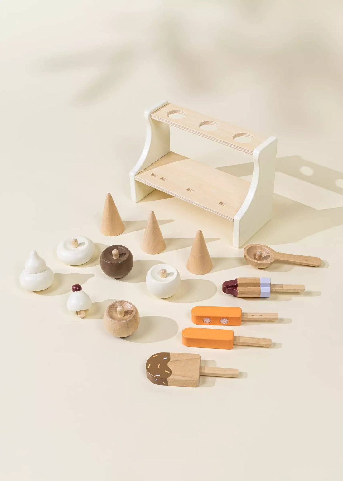 Wooden Ice Cream Stand play food set: cones, scoops, popsicles in natural wood, white, brown, orange, purple, flat lay.