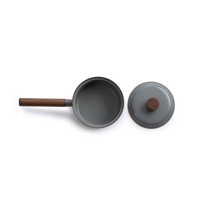 
                    
                      Enamel saucepan with walnut handle, grey enamel finish, stainless steel rim. Flat lay, top-down view with lid removed beside…
                    
                  