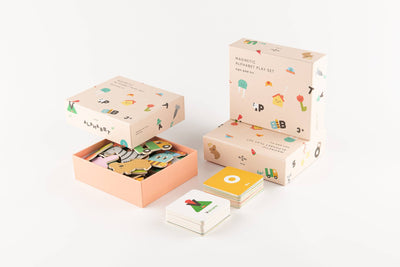 
                    
                      Magnetic Alphabet Play Set, three peach illustrated boxes (one open, showing colorful animal pieces) and two stacks of word…
                    
                  