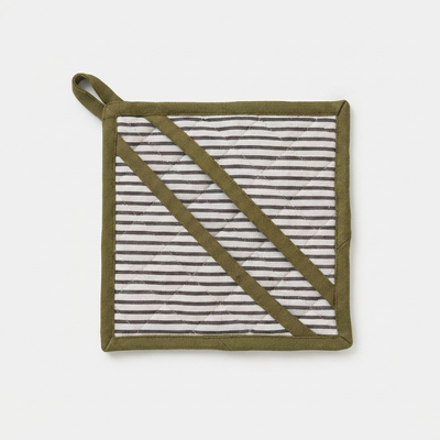 
                    
                      Sylvie Thiriez Aux Petits Oignons oven mitt, green binding, white and black striped quilted fabric, flat lay front view.
                    
                  
