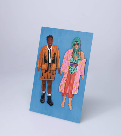 
                    
                      Fearless Fashion magnetic dolls: two paper figures, one in orange rabbit jacket, one in pink banana robe, angled on blue.
                    
                  