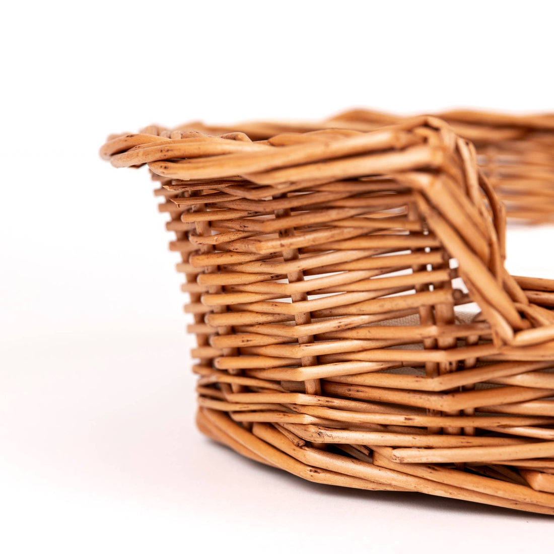 Wicker Dog Basket, natural woven willow, close-up showing intricate side weave and sturdy rim detail.
