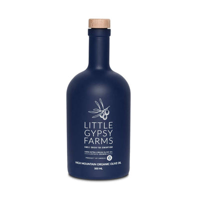 
                    
                      Little Gypsy Farms High Mountain Organic Olive Oil, 500ml navy blue bottle with wood cap, white label text and olive branch,…
                    
                  