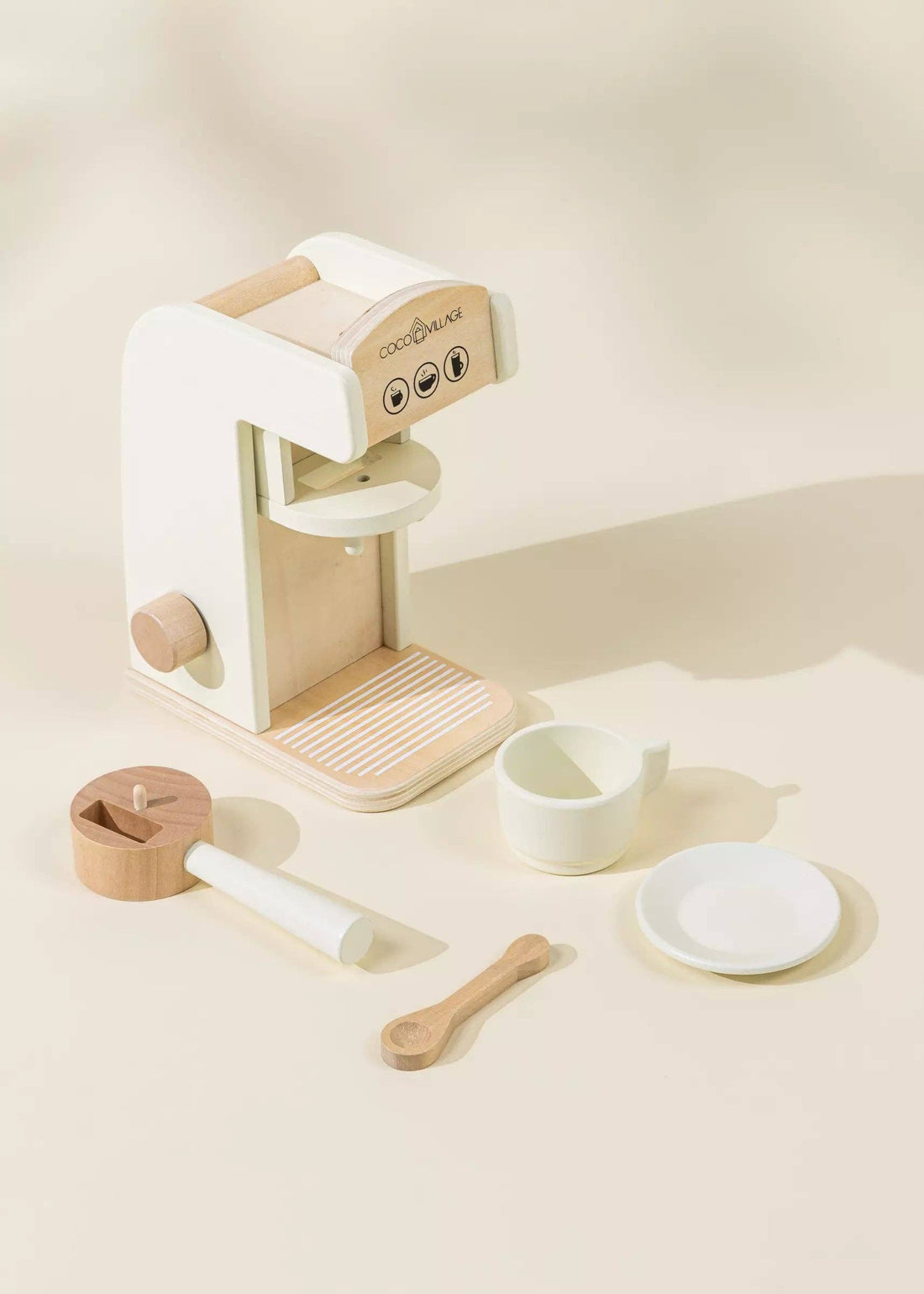 Wooden Coffee Maker play set, white and natural wood. Complete set flat lay with coffee machine, cup, saucer, spoon
