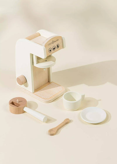 
                    
                      Wooden Coffee Maker play set, white and natural wood. Complete set flat lay with coffee machine, cup, saucer, spoon
                    
                  