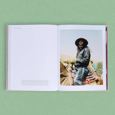 
                    
                      The New Black West book, pages open to a spread with text on the left and a photo of a Black man riding a horse on the right.
                    
                  