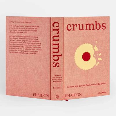 
                    
                      Phaidon Crumbs cookbook, light pink textured hardcover, angled view showing back cover description.
                    
                  