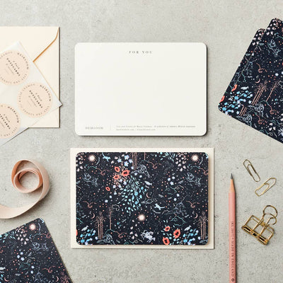 
                    
                      Zodiac Notecards, black celestial pattern front, ivory cardstock back with 'FOR YOU,' envelope, and stickers, flat lay.
                    
                  