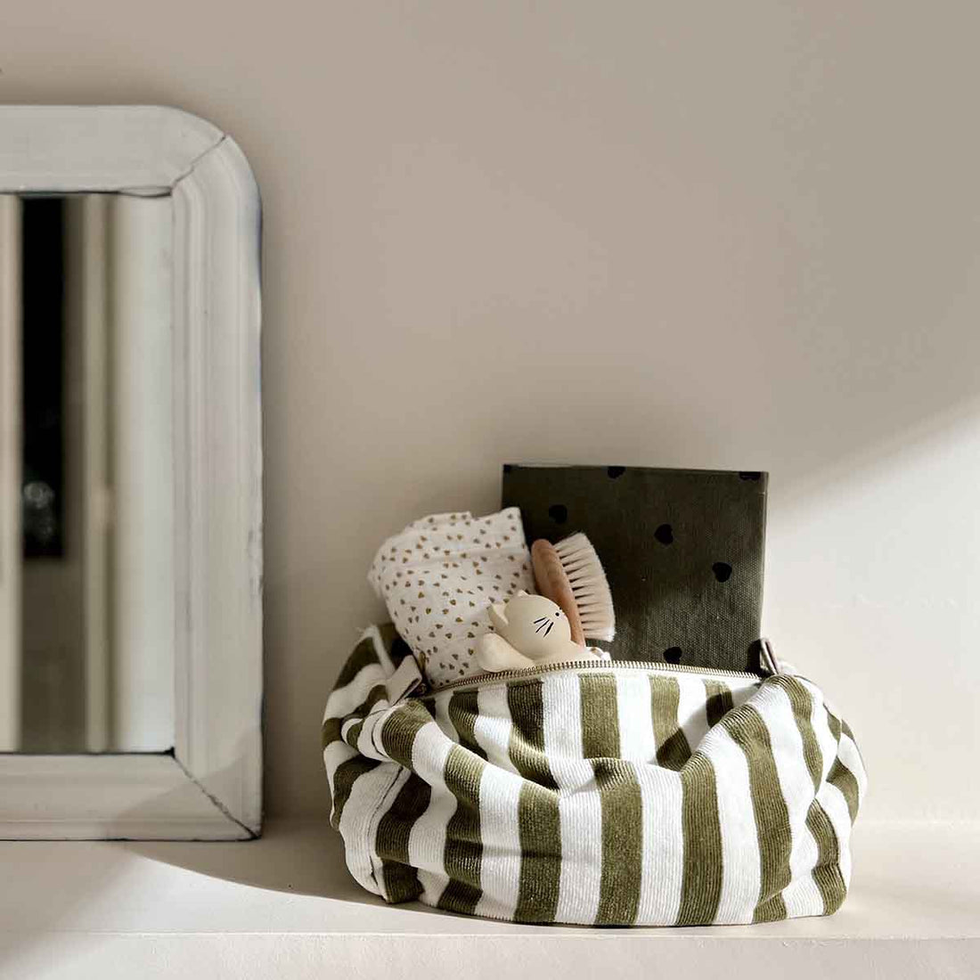 Vic Toiletry Bag, olive green and white striped cotton terry, upright and open with interior details visible.