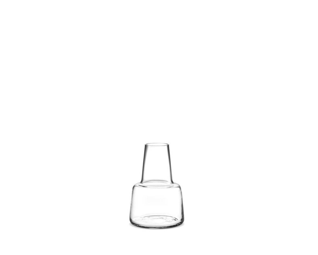 Flora clear mouth-blown glass vase, featuring a tapered neck and rounded base, front on white.