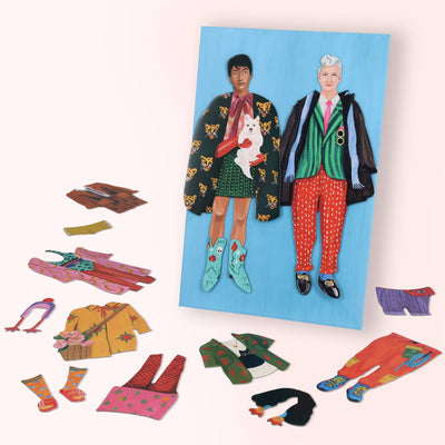 
                    
                      Fearless Fashion magnetic doll set, two diverse dolls on a blue board, surrounded by colorful paper magnet outfits with…
                    
                  