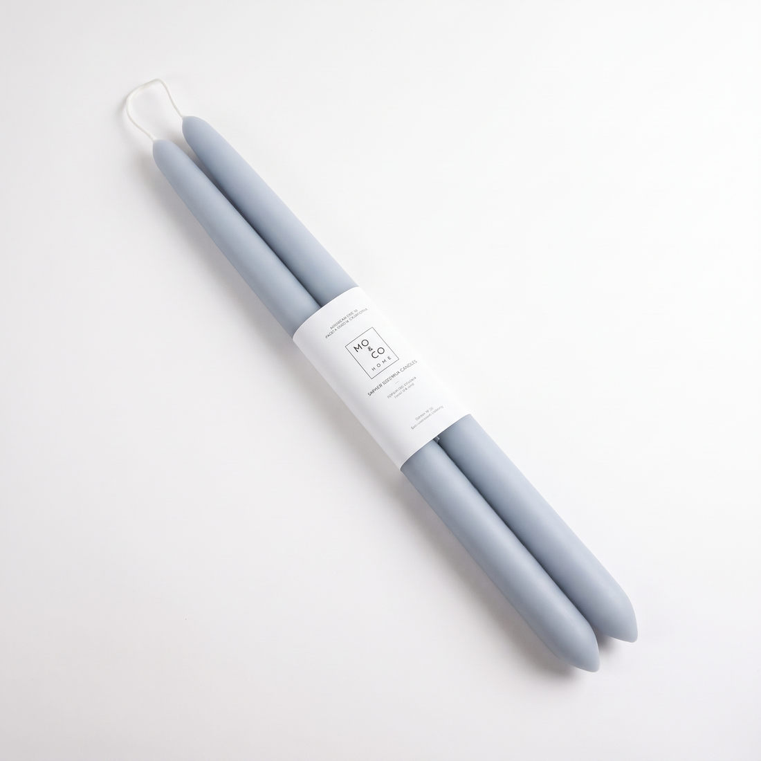 Mo&Co Home Bluebell Dipped Beeswax Taper Candles studio product photo on a neutral off-white background
