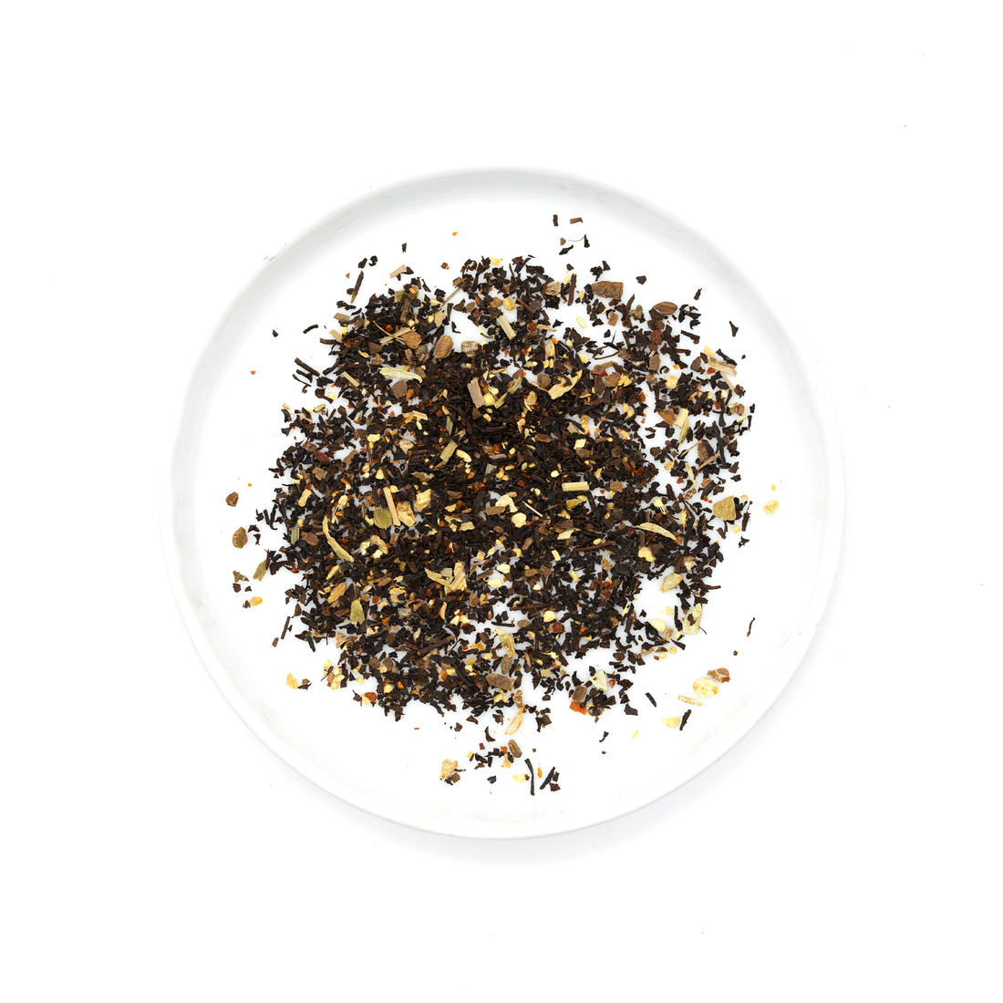 Gochujang Chai loose blend on white plate, an overhead flat lay showing dark tea leaves, light brown spices, and reddish…